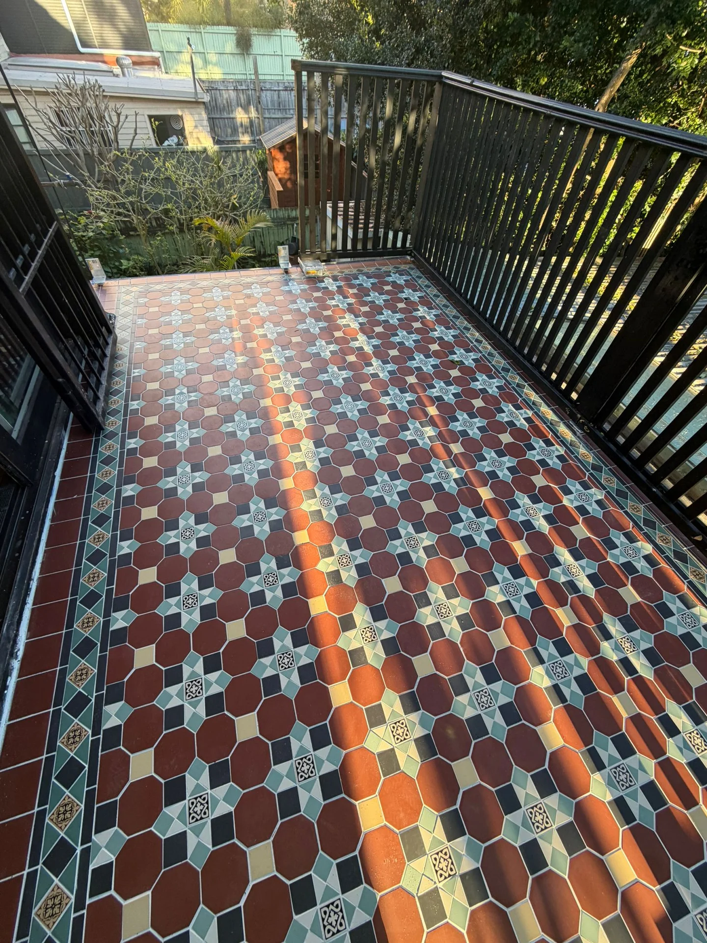 Multicoloured patterned tiles across a balcony